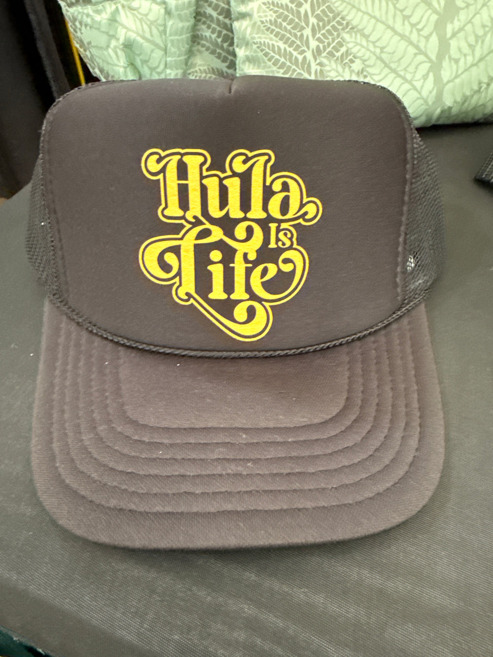 Trucker Hat, black with yellow Hula is Life script design