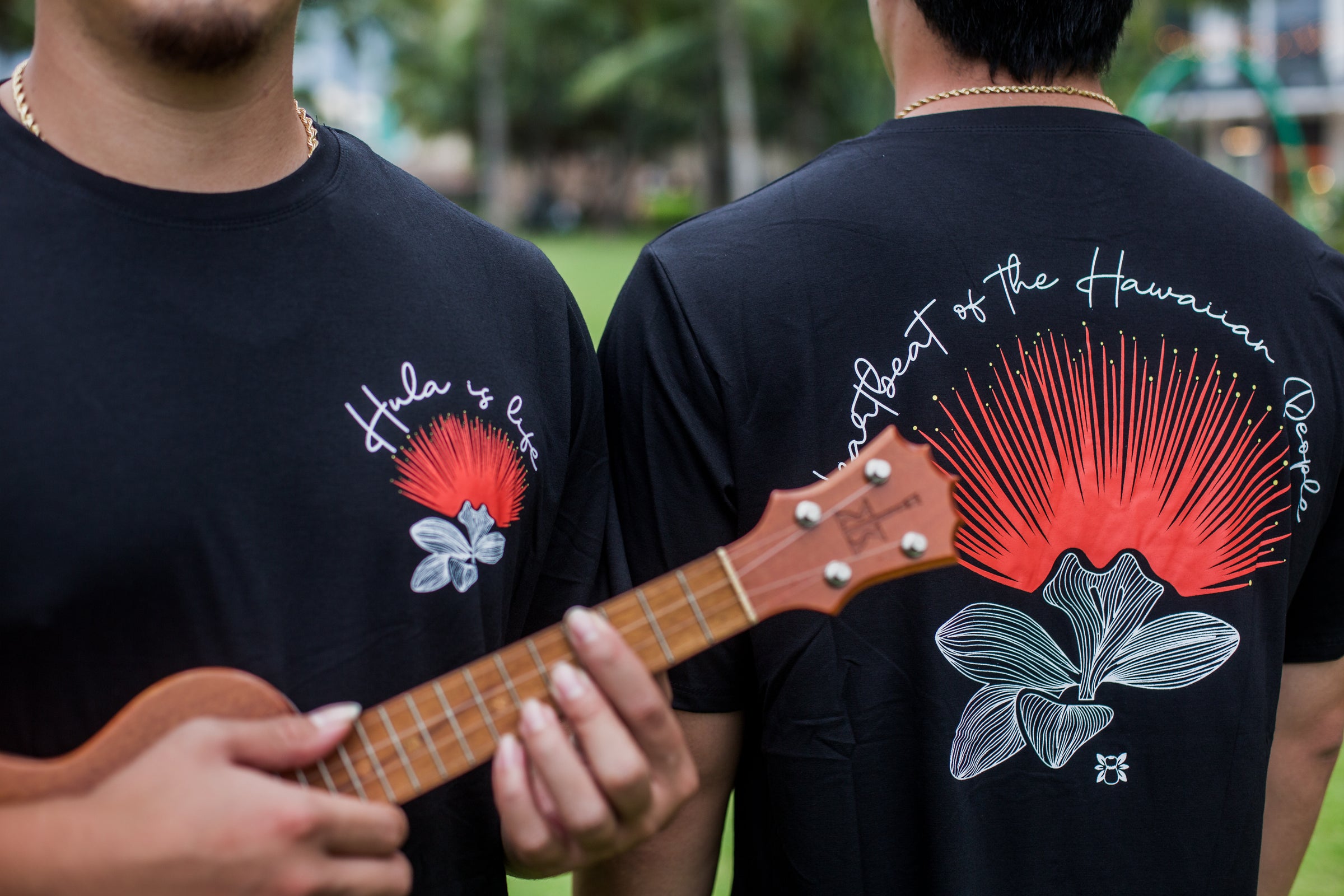 Hula is Life Lehua ʻUla T-shirt featuring a vibrant fern design, worn by the Kora Twins, showcasing Hawaiian-inspired style.