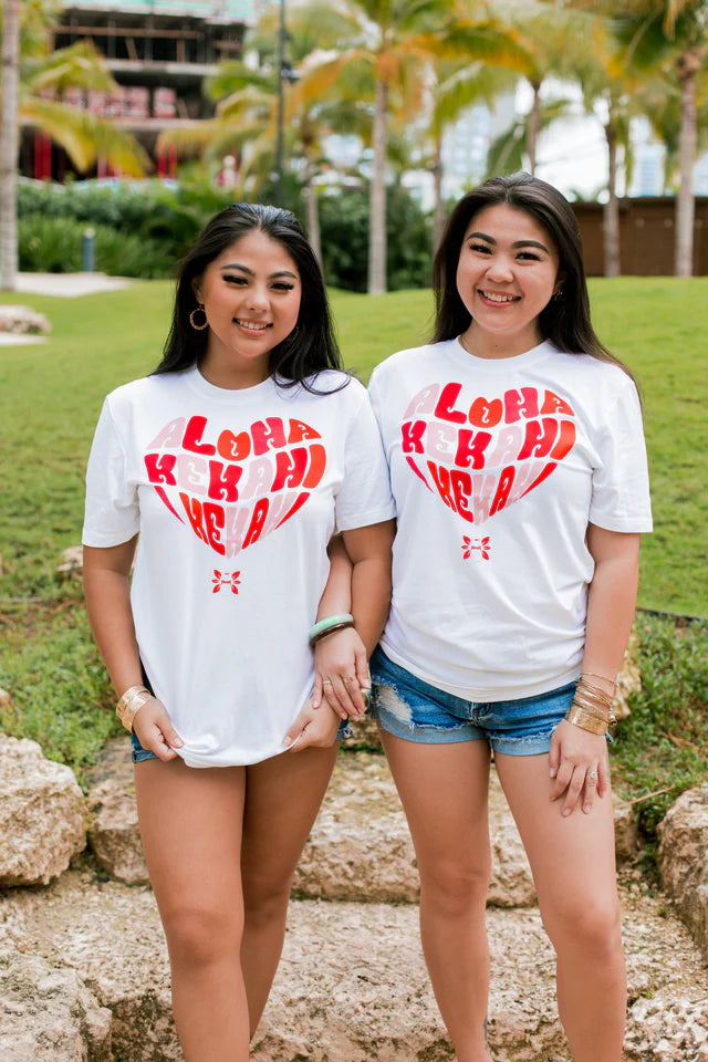 Hula is Life Aloha Puʻuwai T-shirt in XS, featuring a vibrant Hawaiian-inspired design with the words "Aloha Puʻuwai".